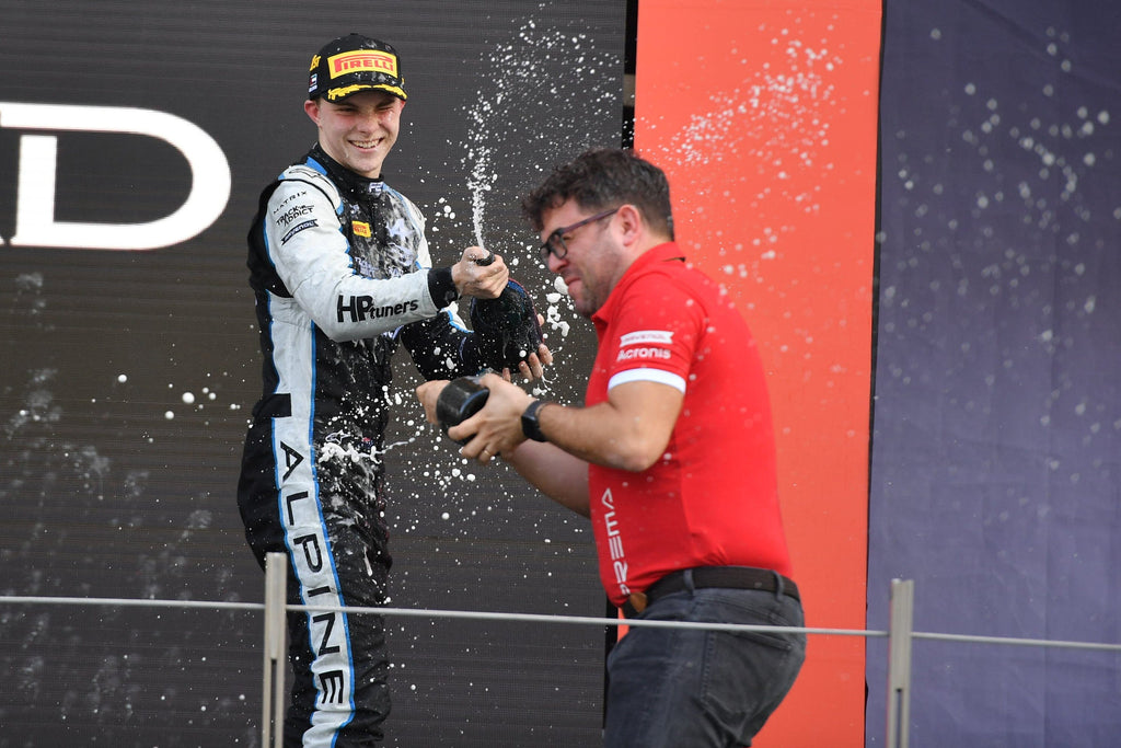 Prema Racing driver Oscar Piastri on Abu Dhabi podium spraying champagne