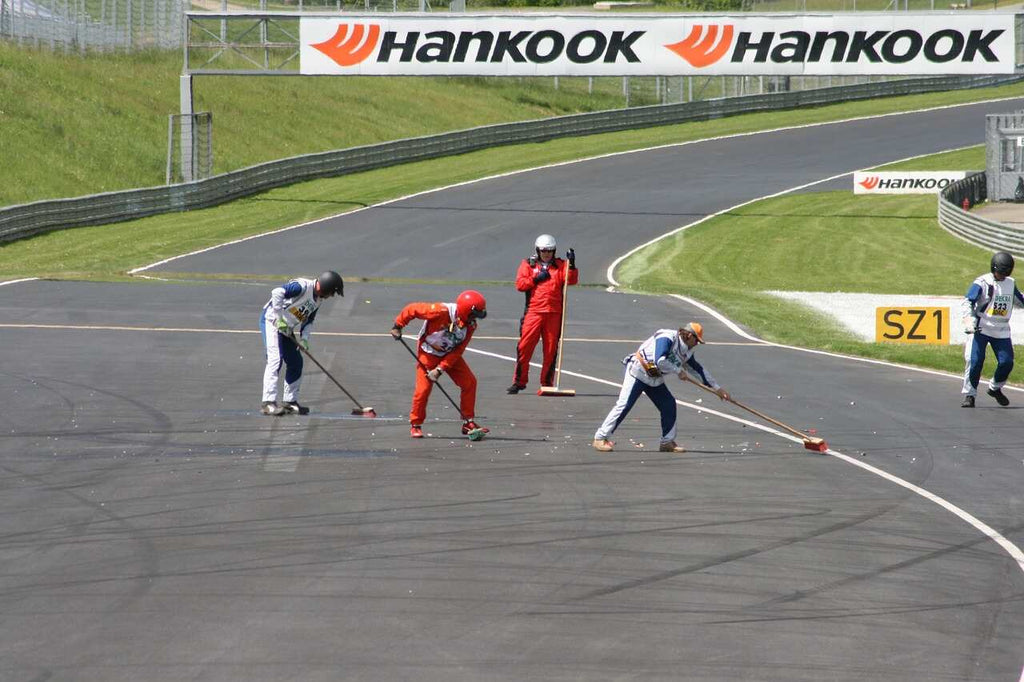 several workers cleaning up race track